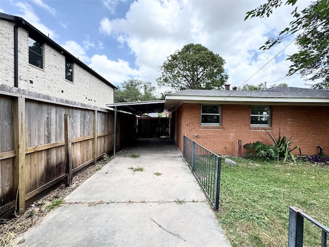 7905 Turquoise Ln, Houston, TX 77055 - view of home's exterior featuring driveway, brick siding, and a carport