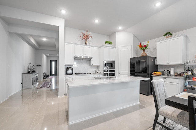 8703 Winter Edge Dr, Richmond, TX 77407 - kitchen with white cabinetry, decorative backsplash, a sink, stainless steel appliances, and a kitchen island with sink
