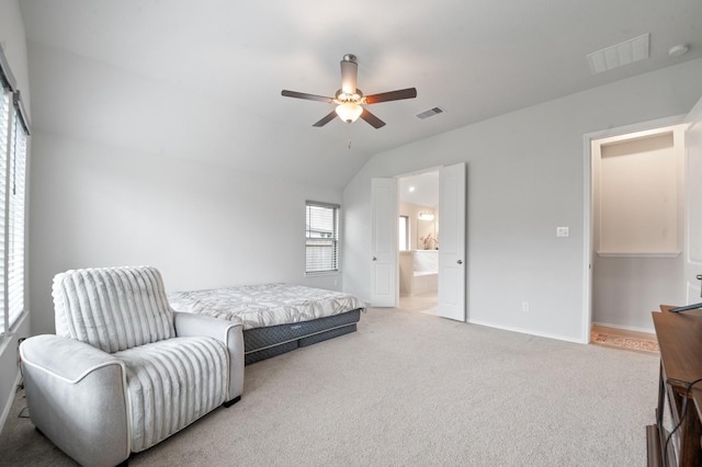 8703 Winter Edge Dr, Richmond, TX 77407 - carpeted bedroom with connected bathroom, visible vents, lofted ceiling, and baseboards