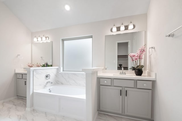 8703 Winter Edge Dr, Richmond, TX 77407 - bathroom featuring two vanities, a bath, marble finish floor, and a sink
