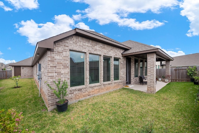 8703 Winter Edge Dr, Richmond, TX 77407 - back of house featuring a patio, roof with shingles, fence, a yard, and brick siding