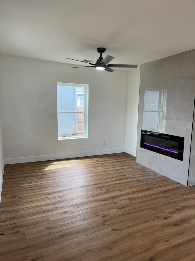 4414 Orange St, Houston, TX 77020 - unfurnished living room with baseboards, a tile fireplace, and wood finished floors
