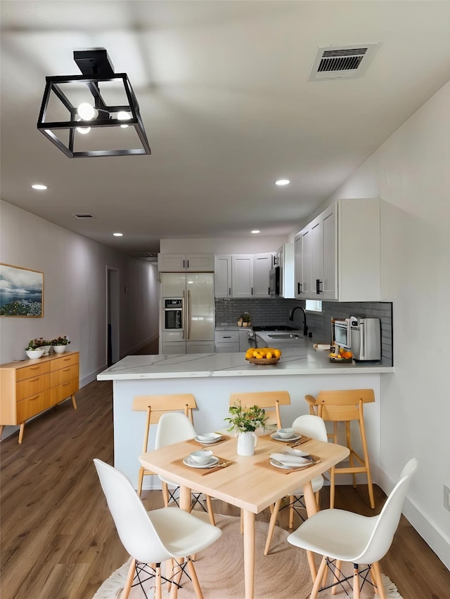 4414 Orange St, Houston, TX 77020 - dining space featuring visible vents, recessed lighting, baseboards, and dark wood-type flooring