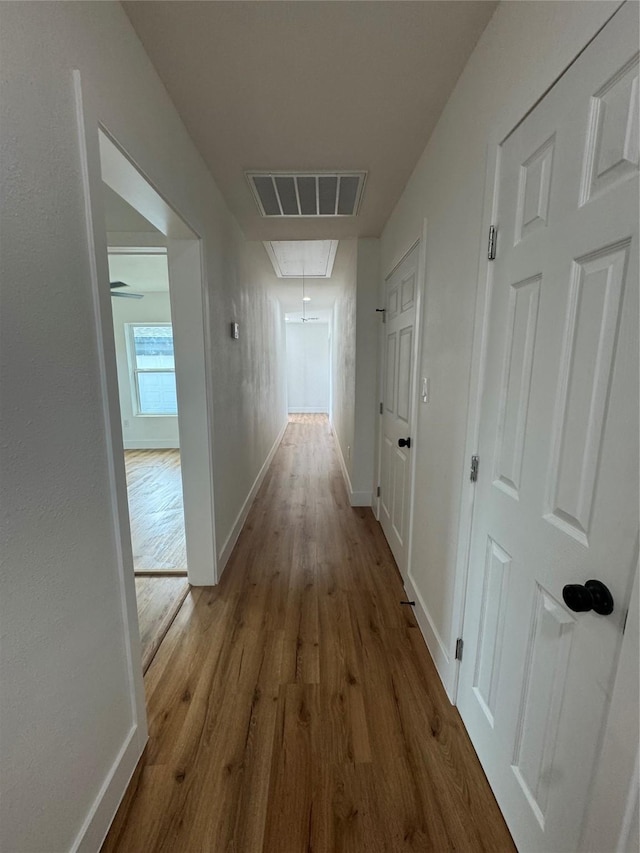 4414 Orange St, Houston, TX 77020 - corridor featuring visible vents, attic access, baseboards, and wood finished floors