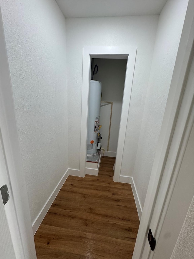 4414 Orange St, Houston, TX 77020 - corridor with wood finished floors, baseboards, and gas water heater