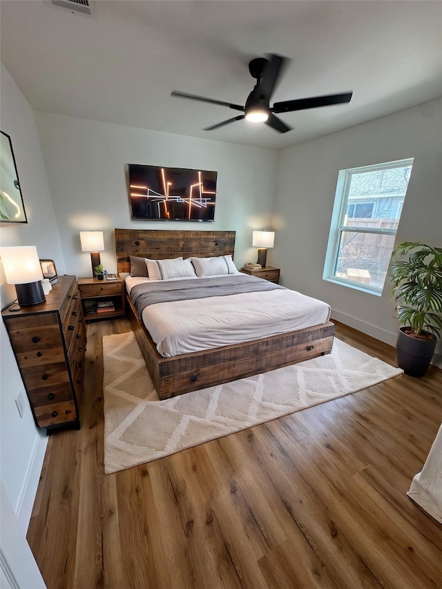 4414 Orange St, Houston, TX 77020 - bedroom featuring baseboards, ceiling fan, wood finished floors, and visible vents