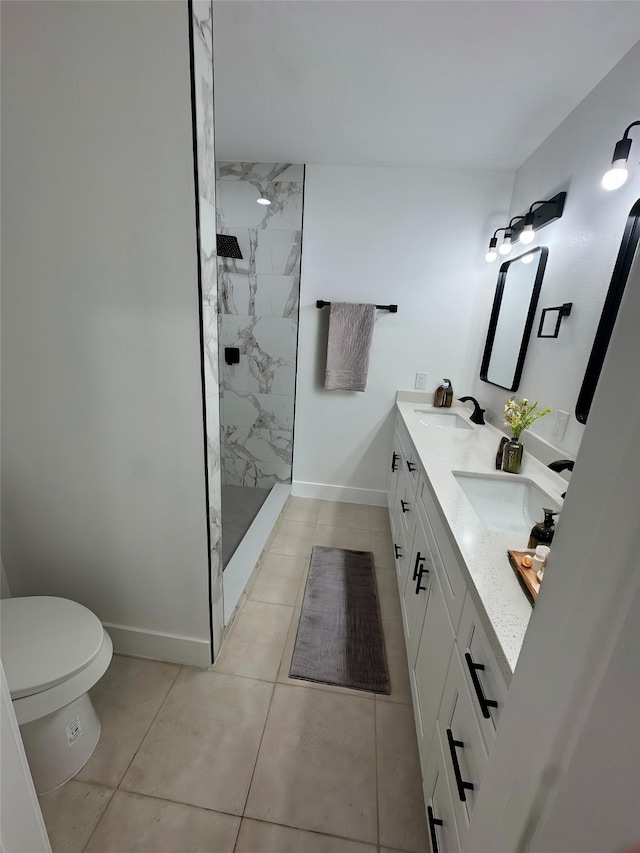 4414 Orange St, Houston, TX 77020 - full bath with a sink, tile patterned flooring, toilet, baseboards, and tiled shower