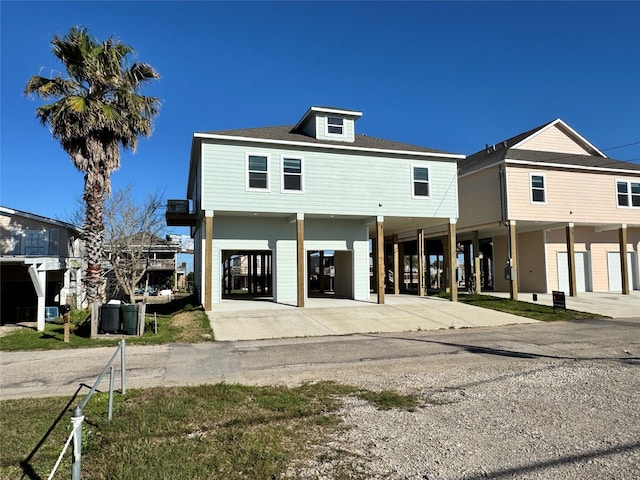 view of front of property with driveway and a carport