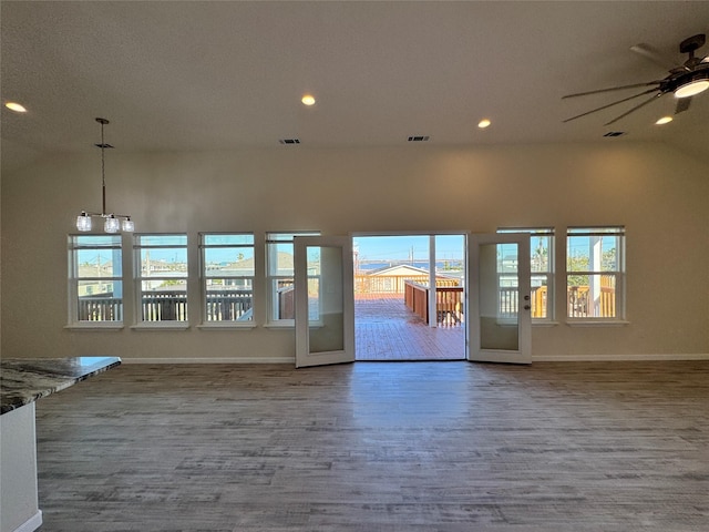 unfurnished living room with baseboards, a ceiling fan, french doors, and wood finished floors