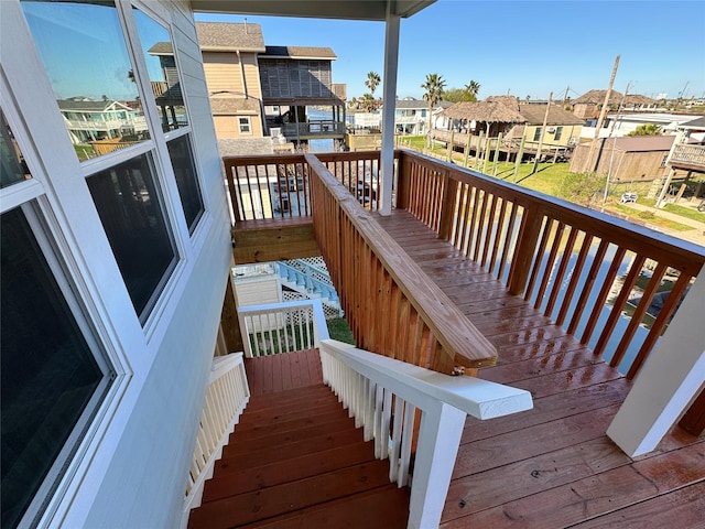 wooden terrace with stairway and a residential view