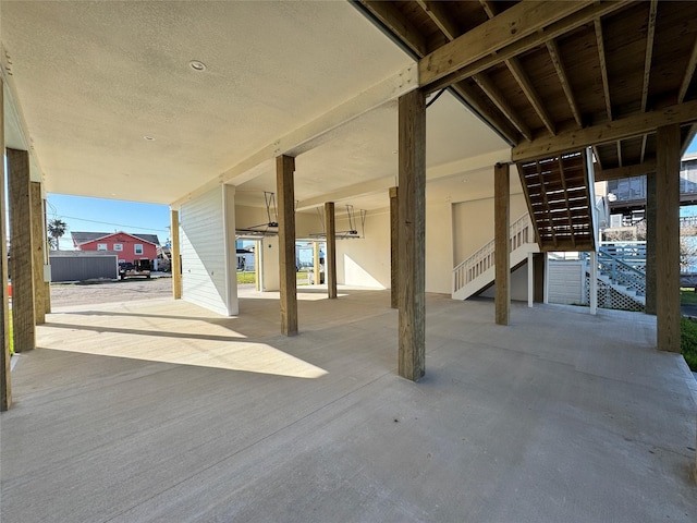 view of patio / terrace featuring stairway and a carport