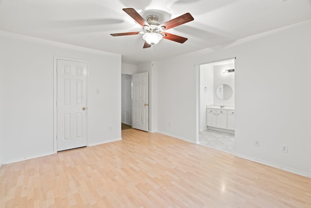 8010 Fox St, Baytown, TX 77523 - unfurnished bedroom featuring light wood finished floors, baseboards, and connected bathroom