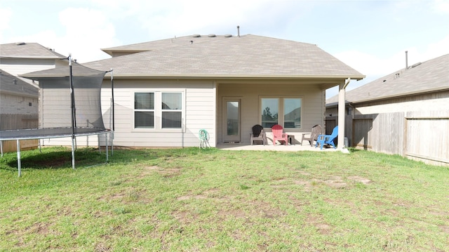 40607 Creekside Bluff Trl, Magnolia, TX 77354 - rear view of house featuring a trampoline, a patio, and roof with shingles