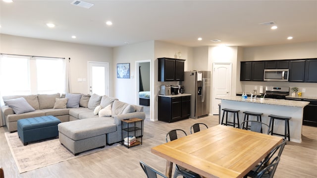 40607 Creekside Bluff Trl, Magnolia, TX 77354 - living room featuring light wood-style flooring and recessed lighting