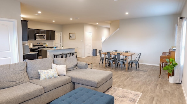 40607 Creekside Bluff Trl, Magnolia, TX 77354 - living room with recessed lighting, baseboards, and light wood-type flooring