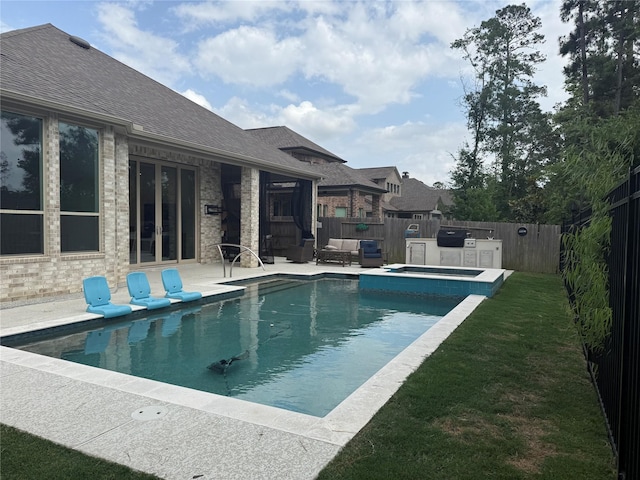 view of swimming pool with an in ground hot tub, french doors, a patio area, a fenced in pool, and a fenced backyard