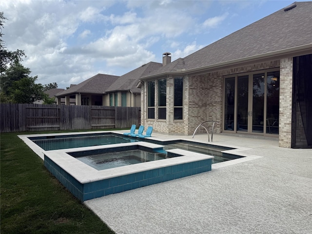 view of pool with fence, a patio, french doors, a fenced in pool, and an in ground hot tub