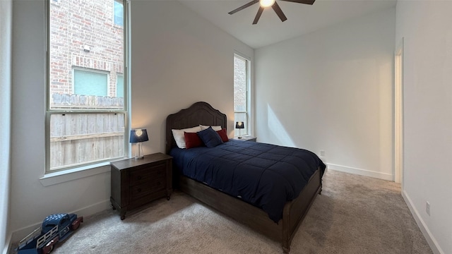 bedroom featuring carpet flooring, a ceiling fan, baseboards, and lofted ceiling