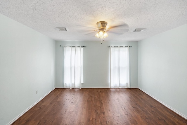 spare room featuring plenty of natural light, ceiling fan, and visible vents