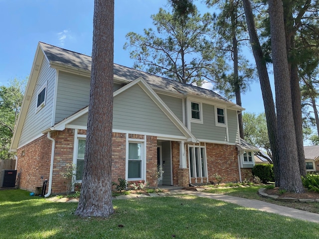 view of front facade featuring brick siding, central AC unit, and a front lawn