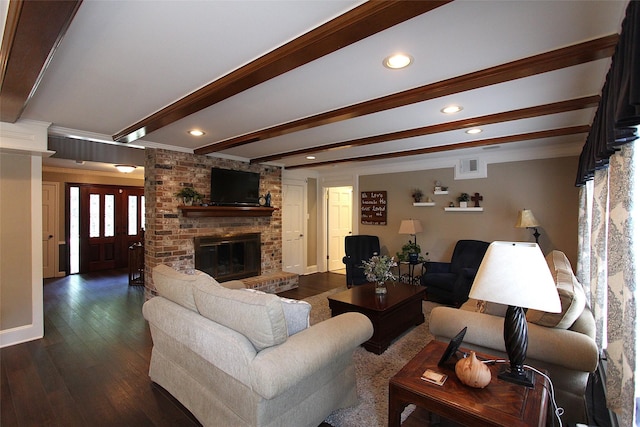 living area featuring recessed lighting, visible vents, dark wood-type flooring, beam ceiling, and a brick fireplace