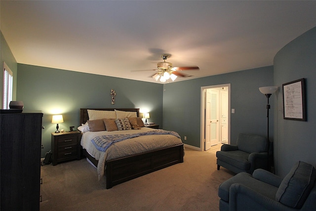 bedroom featuring ceiling fan, light carpet, and baseboards