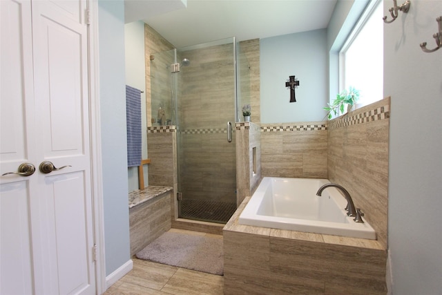 bathroom with a bath and a shower stall