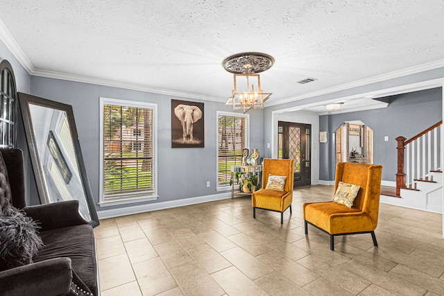 sitting room with stairway, crown molding, a textured ceiling, an inviting chandelier, and visible vents