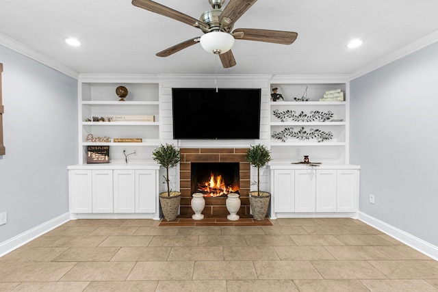unfurnished living room with ceiling fan, baseboards, a warm lit fireplace, and ornamental molding