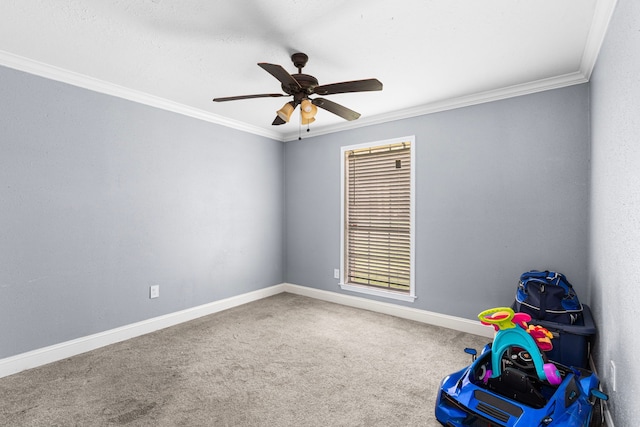 game room with ceiling fan, baseboards, ornamental molding, and carpet flooring