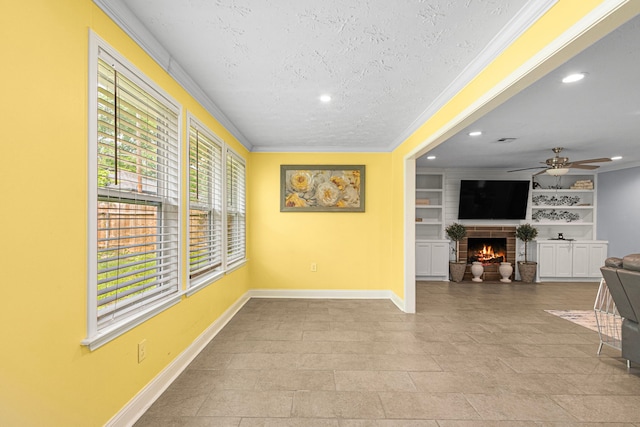 interior space with a textured ceiling, baseboards, recessed lighting, a ceiling fan, and crown molding