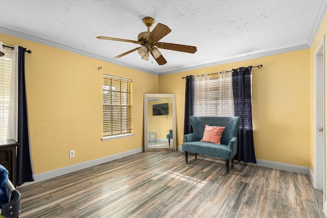 sitting room featuring baseboards, wood finished floors, a textured ceiling, and ceiling fan
