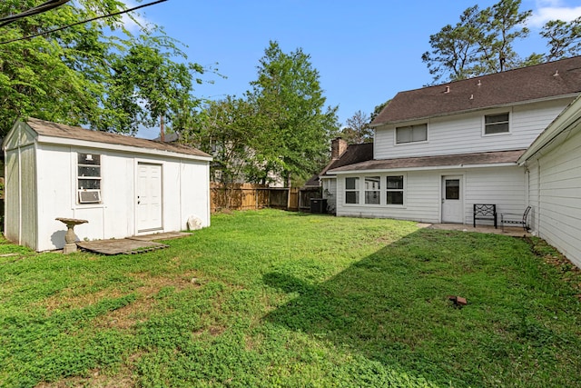 view of yard featuring a fenced backyard and an outbuilding