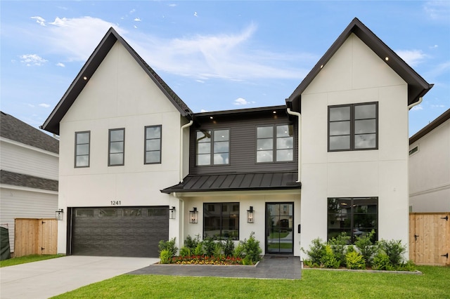 modern farmhouse with a front lawn, a standing seam roof, stucco siding, and fence