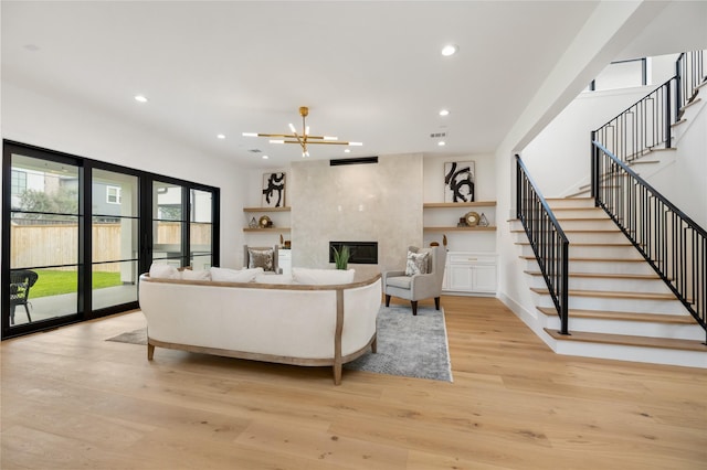 living area with stairs, light wood finished floors, and recessed lighting