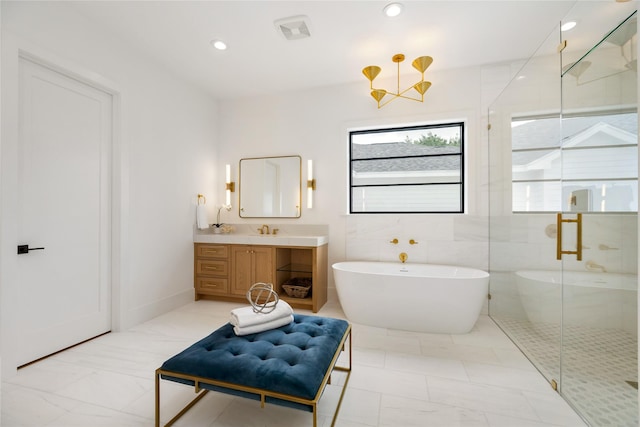 bathroom with a shower stall, marble finish floor, visible vents, vanity, and a freestanding tub
