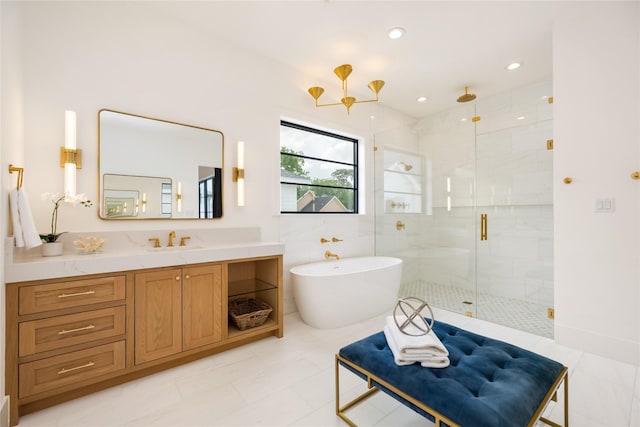 full bath featuring vanity, a freestanding tub, recessed lighting, and a shower stall