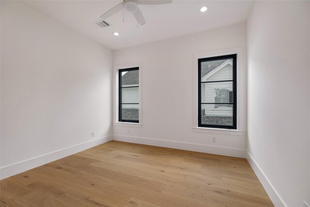 unfurnished room with light wood-type flooring, visible vents, baseboards, and ceiling fan