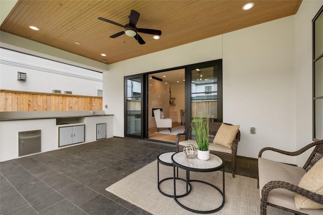 view of patio with a ceiling fan, a sink, and area for grilling
