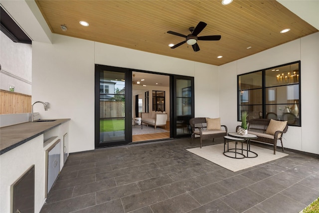 view of patio featuring a sink, area for grilling, and ceiling fan