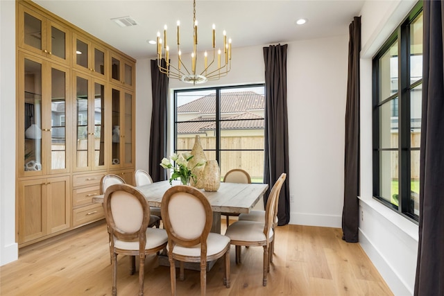 dining room featuring an inviting chandelier, light wood finished floors, baseboards, visible vents, and recessed lighting