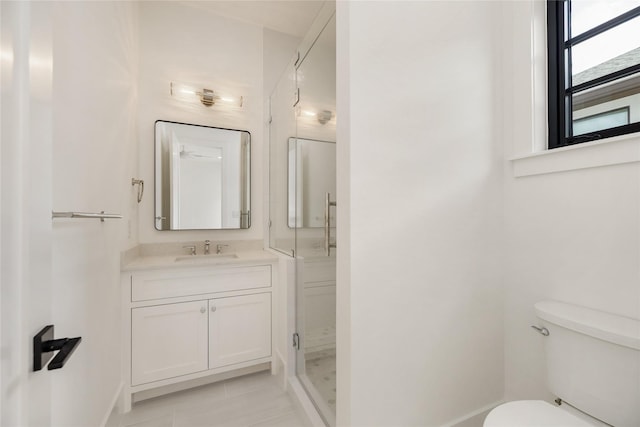 bathroom featuring tile patterned flooring, vanity, toilet, and baseboards