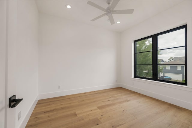 spare room featuring baseboards, light wood finished floors, and recessed lighting