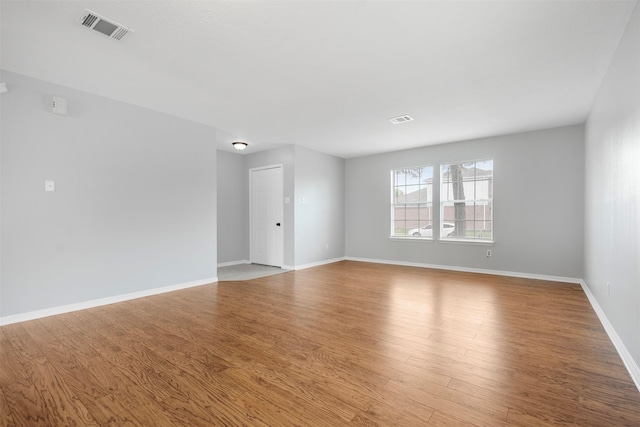 8027 Lavage Ln, Baytown, TX 77521 - empty room with baseboards, wood finished floors, and visible vents