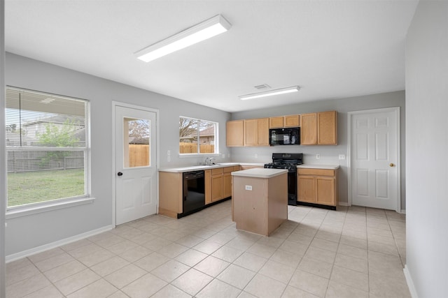 8027 Lavage Ln, Baytown, TX 77521 - kitchen with a center island, a sink, baseboards, light countertops, and black appliances