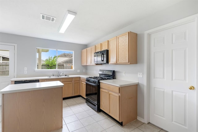 8027 Lavage Ln, Baytown, TX 77521 - kitchen featuring light brown cabinets, a sink, black appliances, light countertops, and visible vents