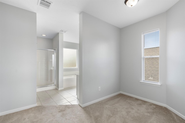 8027 Lavage Ln, Baytown, TX 77521 - unfurnished room with baseboards, visible vents, light colored carpet, and light tile patterned floors