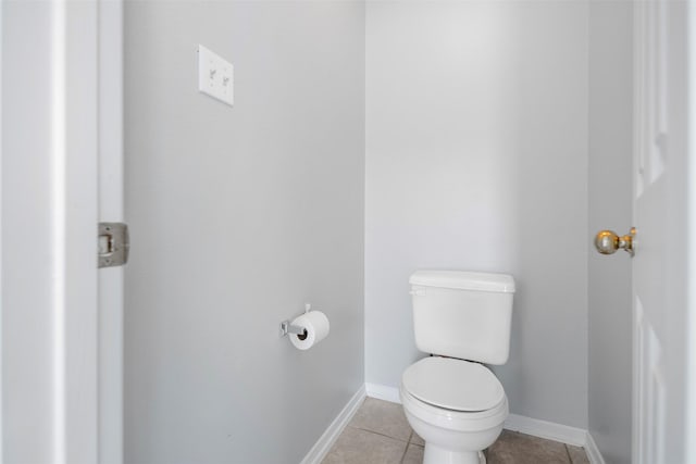 8027 Lavage Ln, Baytown, TX 77521 - bathroom featuring baseboards, toilet, and tile patterned floors