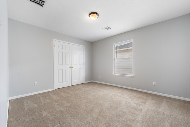 8027 Lavage Ln, Baytown, TX 77521 - unfurnished bedroom with carpet, visible vents, and baseboards