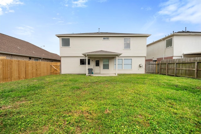 8027 Lavage Ln, Baytown, TX 77521 - rear view of property featuring a lawn, a fenced backyard, and a patio